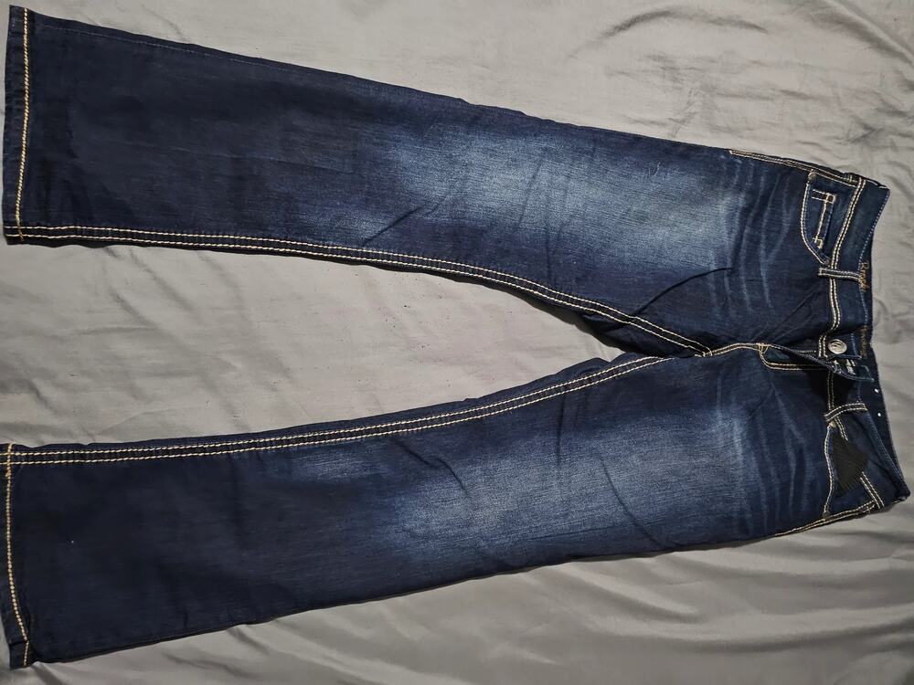 Dark wash denim jeans with contrast stitching and hem measurement photo